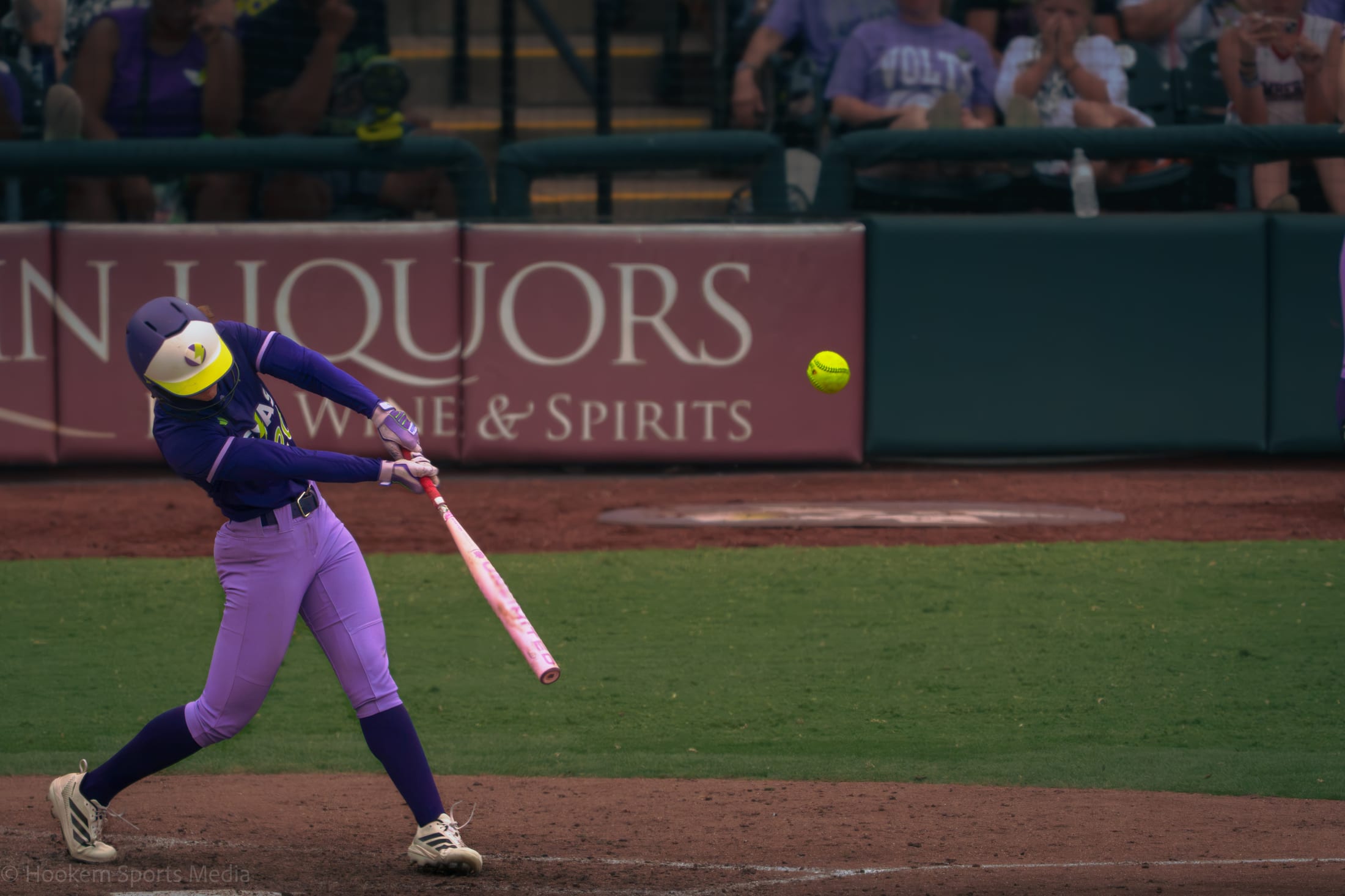Jackie Lis drives a pitch into play for the Texas Volts at Dell Diamond.